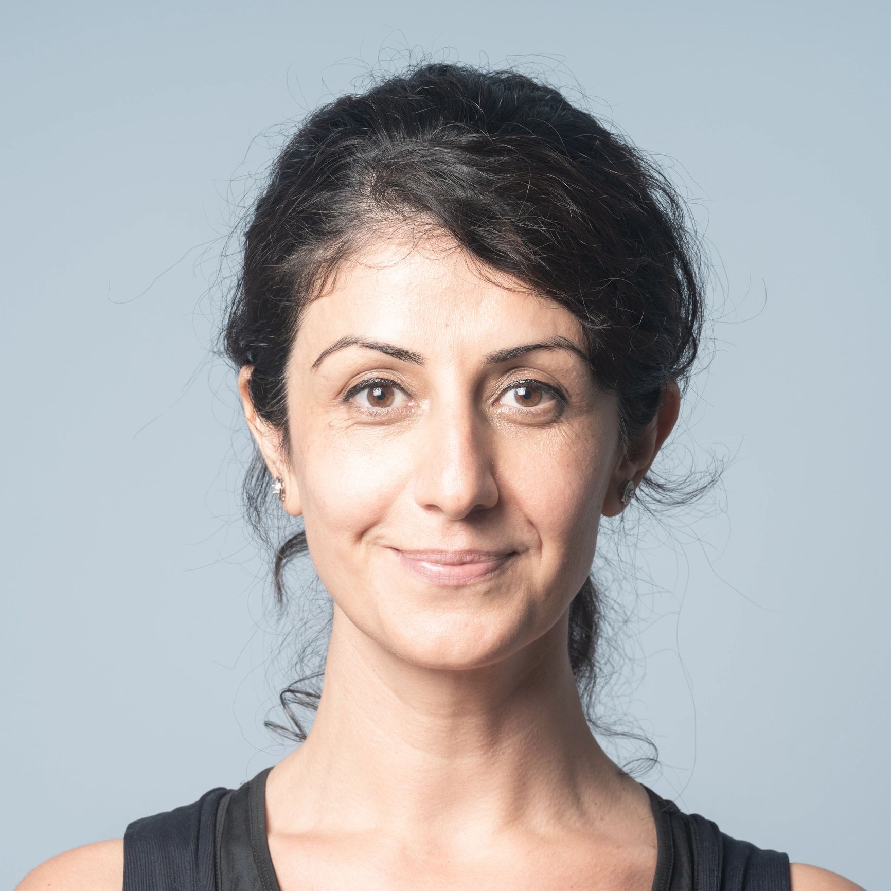 Portrait of a smiling woman in a studio setting